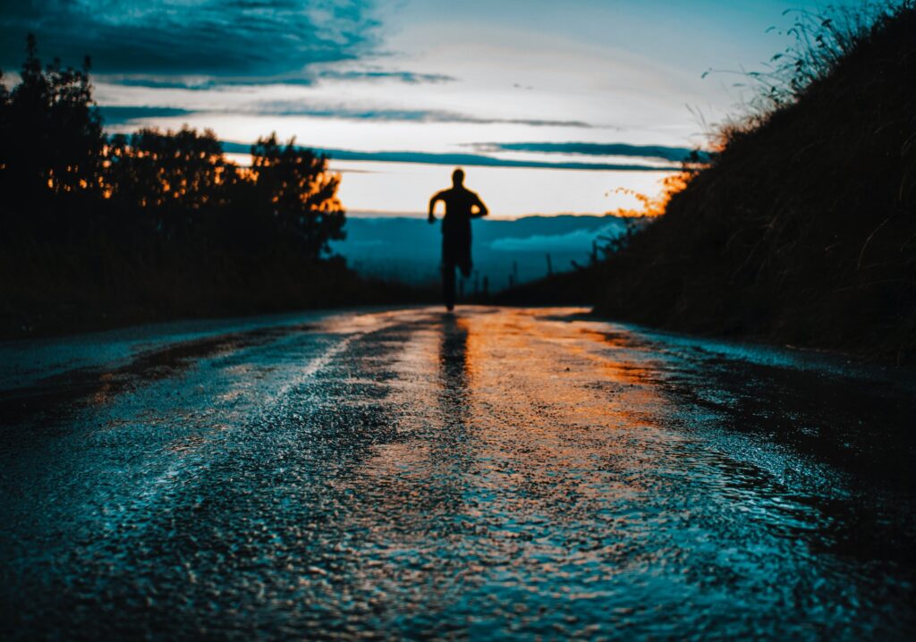 Photo by lucas Favre silhouette photo of a person running on road